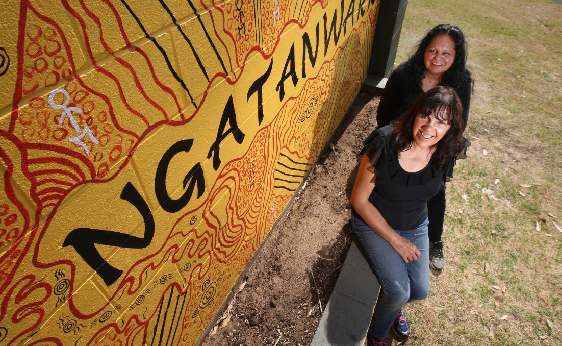 Artists Fiona Clarke (back) and Bronwyn Ferguson in front of their welcome mural.