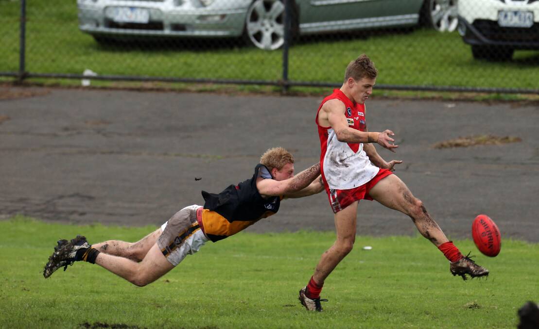 South debutant Kyden Jarvis (right) escapes the clutches of Portland defender Mitch Bunworth to kick his team into attack. Jarvis had a memorable start to his senior career, kicking five goals. 