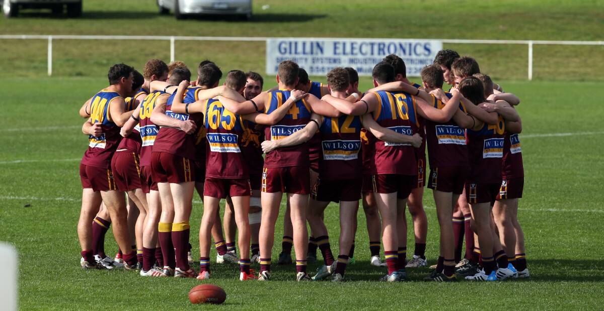 Do it for Carolyn: South Rovers players gather before the first bounce against East Warrnambool on Saturday. 
