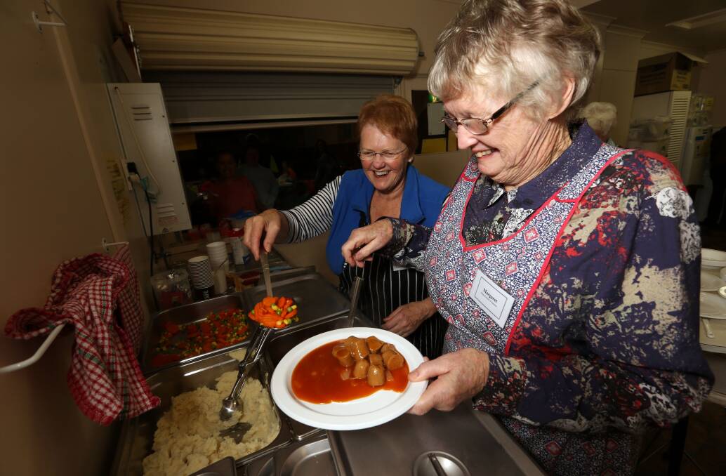Sisters Helen Ellerton (left) and Margaret McCosh volunteer at St Joseph’s hall soup kitchen last night.  140512LP31 Picture: LEANNE PICKETT