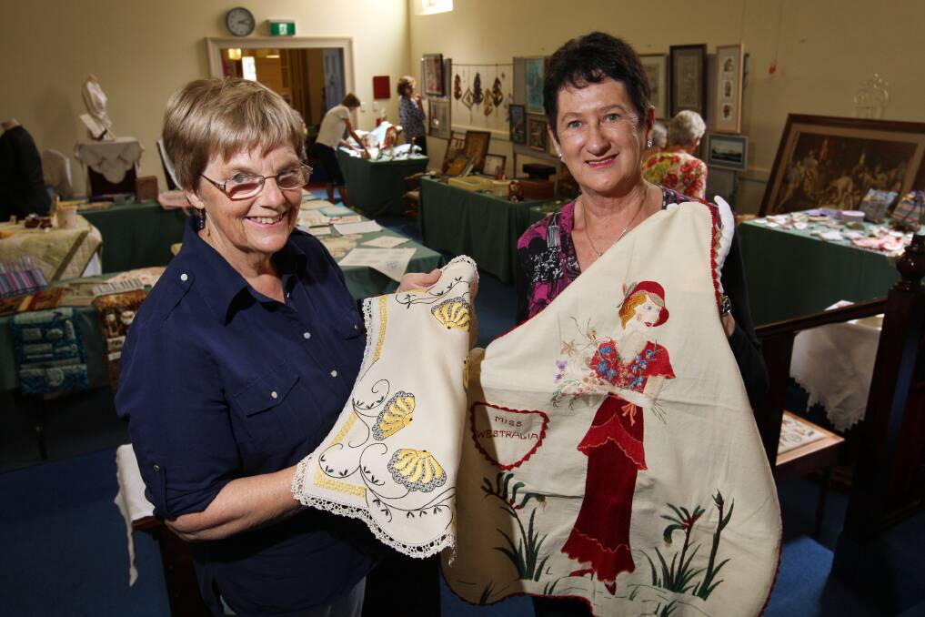 Warrnambool embroiderers Lorraine Blackmore (left) and Brenda Henderson admire some of the works on display in the Warrnambool Masonic lodge hall. 150226LP41 Picture: LEANNE PICKETT