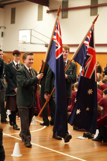 Students Blake Mounsey (left) and Louis Chilton proudly bear the Australian national flags at Brauer College’s pre-Anzac Day service yesterday. 140423LP06 Picture: LEANNE PICKETT