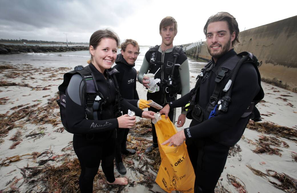 Members of the Deakin Dive Club and Warrnambool Sub Aqua Club Morgan Pumpa (left), Evan Kinn, Sean Kollmer and Ryan Jaques helped clear the sea floor in Lady Bay beside the breakwater as part of Clean Up Warrnambool Weekend on Saturday — and what they found was not pretty. 