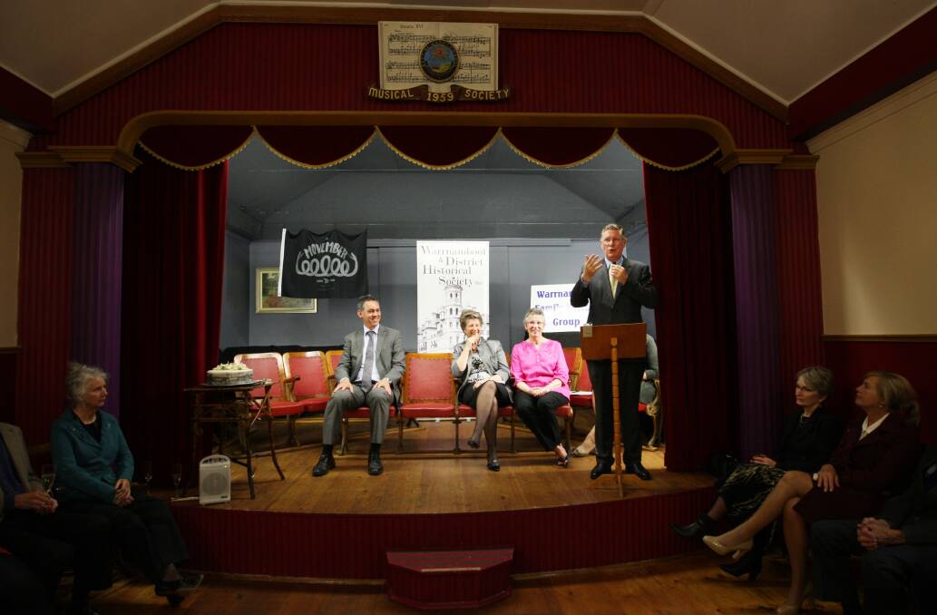 Premier Denis Napthine takes front of stage to officially open the Heritage Works Centre in the Mozart Hall on Friday night, watched by mayor Michael Neoh, president of the Warrnambool Family History Group Judy Miller and president of the Mozart Choral Group, Pam King.   