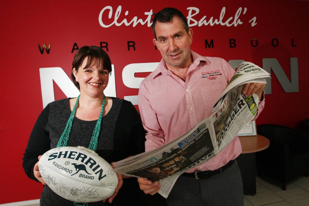 Footy competition winner Jacinta Curran, of Dennington,  with Clinton Baulch from Clinton Baulch’s Motor Group. 140814LP01 Picture: LEANNE PICKETT