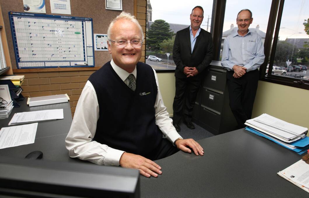 Miles Coverdale tidies his desk at Westvic Staffing Solutions, with chairman Peter Rock (left) and acting CEO Dennis Farley. 140519AM20 Picture: ANGELA MILNE