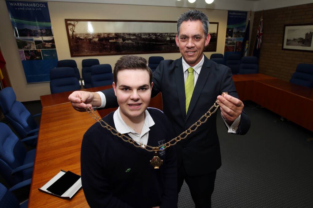 Warrnambool mayor Michael Neoh presents his new youth counterpart Declan Primmer, 16, with the mayoral bling yesterday. Declan will head the Warrnambool Youth Council.       140513DW61 Picture: DAMIAN WHITE