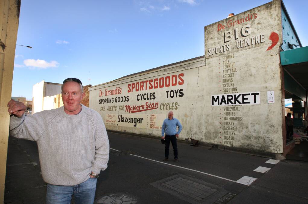 Michael De Grandi (front) and Cr Peter Hulin believe the wall of the former De Grandi’s Sportsgoods store is a piece of the city’s commercial history worth preserving. 140728LP17 Picture: LEANNE PICKETT