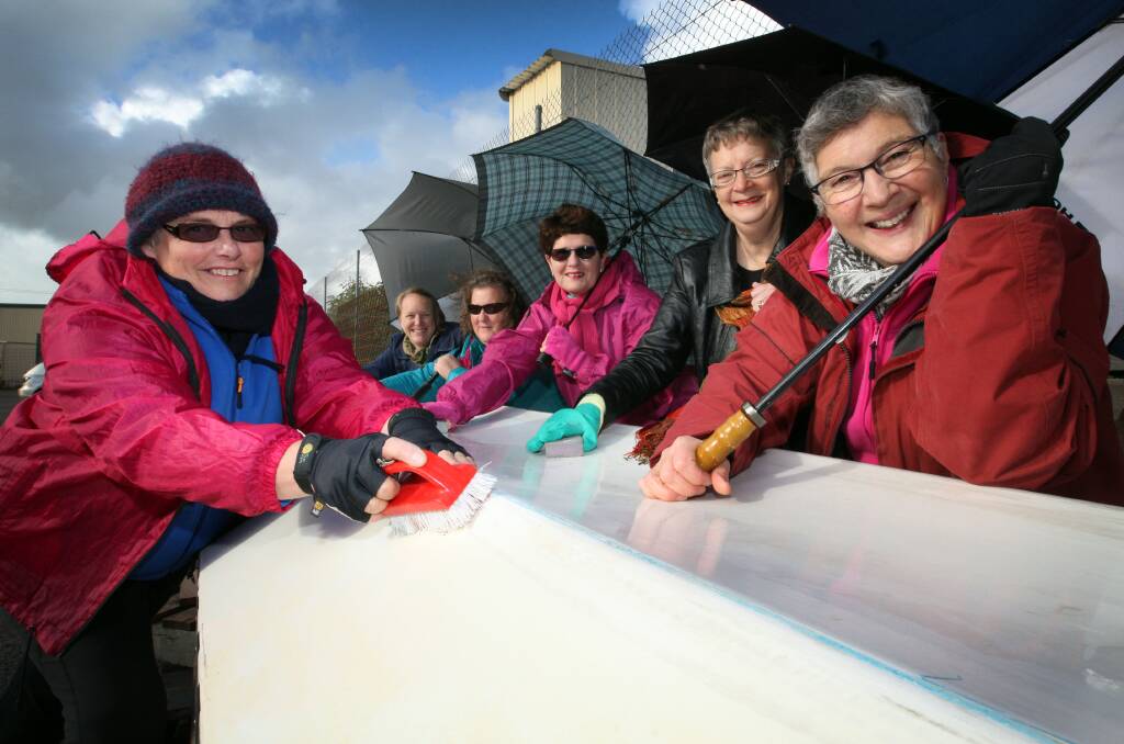 Warrnambool dragon boat enthusiasts, the South C Dragons,  need an indoor home for their boats to prepare them for the coming racing season. Claire Norman (left), Jan Barton, Marlene O’Brien, Ann Krause, Judy Conn and Judy Umney now have to rug up to carry out maintenance outdoors. 140717LP32 Picture: LEANNE PICKETT