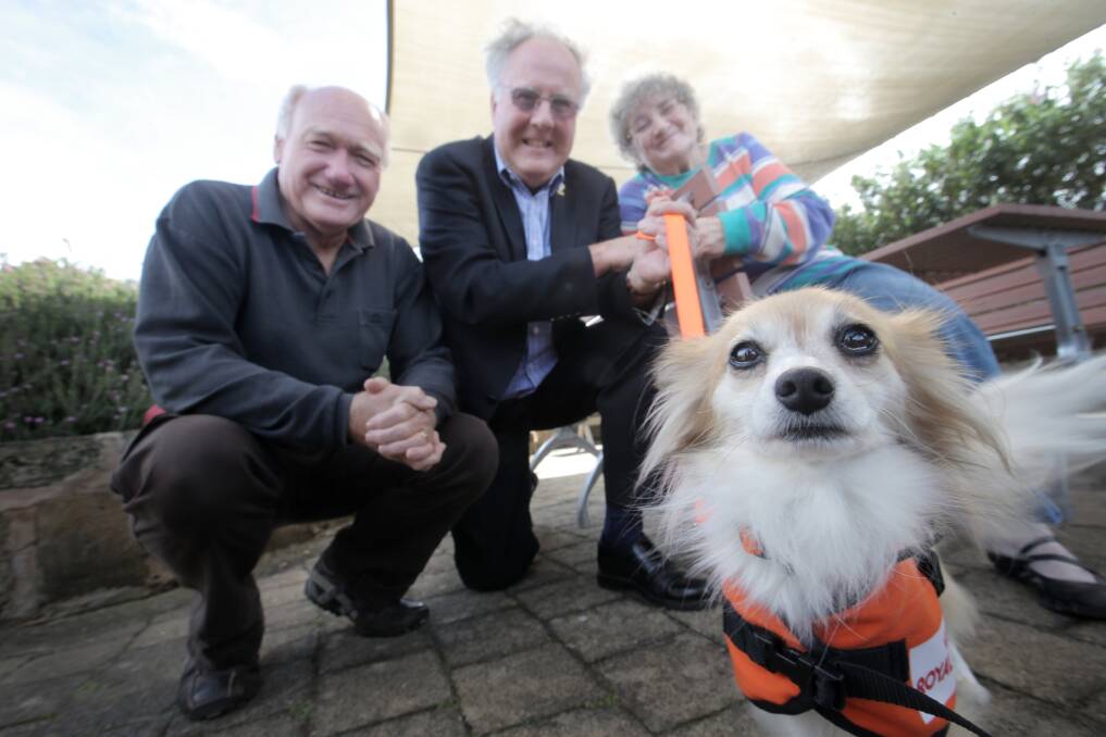 Hearing dog Tess gets to know her new home with Judy Mugavin (rear) after being donated by Warrnambool Lions Club secretary John Tankard (left) and president Rob Cameron.