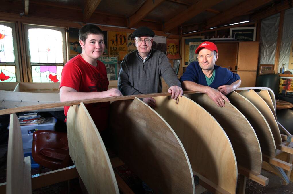 Warrnambool St Ayles Skiff Community Rowing Club members Korey Bawden, 16, Larry Abrahams and Greg Bawden with a skiff taking shape in Mr Abraham’s shed.
140815LP46 Picture: LEANNE PICKETT