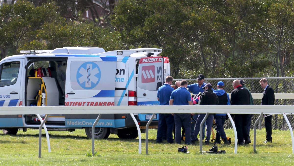 On-course medical staff look after the two jockeys who fell at yesterday’s Warrnambool jumps meeting. A wait of more than an hour for sufficient ambulances almost cancelled the next race. 140825RG02 Picture: ROB GUNSTONE