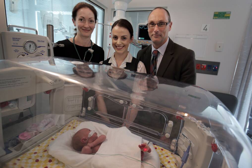South West Healthcare’s paediatric registrar Dr Kathleen McGrath (left), midwife Jess Holder and nurse unit manager Peter Logan with newborn Michaela Jean Lamb, of Hamilton. The hospital is raising money for a new teleconference facility for the neonatal unit. 
140429RG13 Picture: ROB GUNSTONE