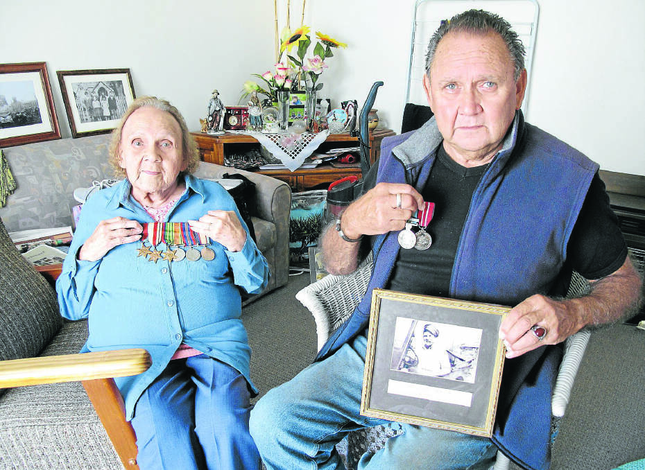 Aunty June Gill (left) of Portland holds her father Samuel Lovett’s World War II medals, and Stewart Lovett a photograph of his brother Murray and his service medals.150422EH01