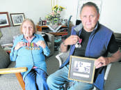 Aunty June Gill (left) of Portland holds her father Samuel Lovett’s World War II medals, and Stewart Lovett a photograph of his brother Murray and his service medals.150422EH01