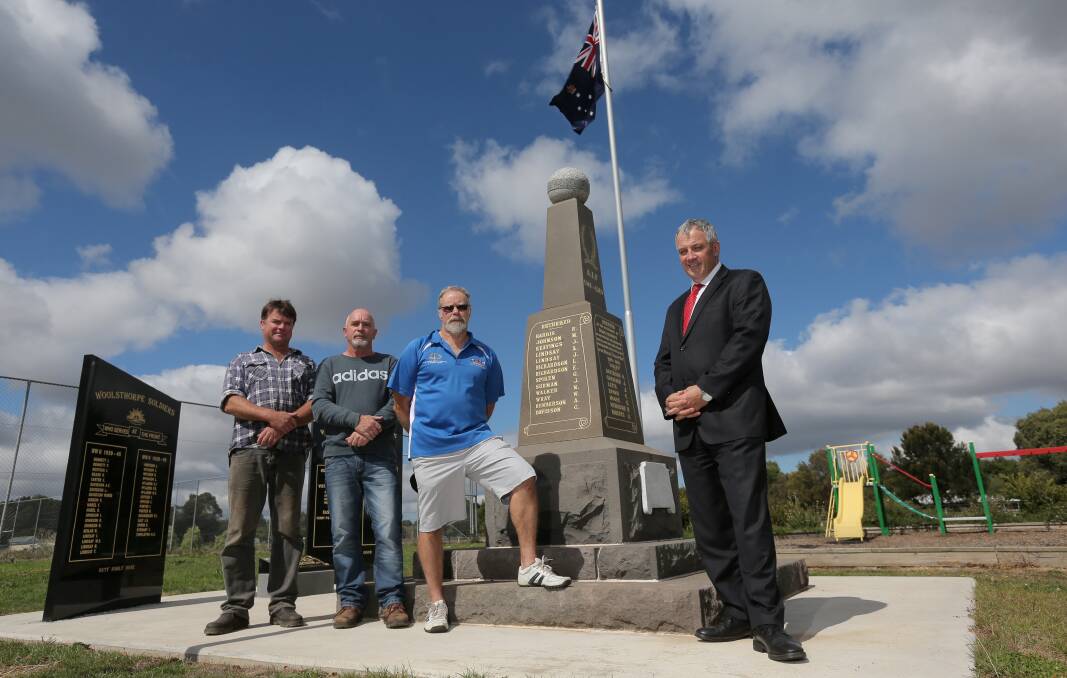 Woolsthorpe Community Progress Association committee members (from left) Sam Robinson, Denis Richardson and Ray Walker with Moyne Shire mayor Colin Ryan at the town’s refurbished war memorial.  Pictures: AARON SAWALL