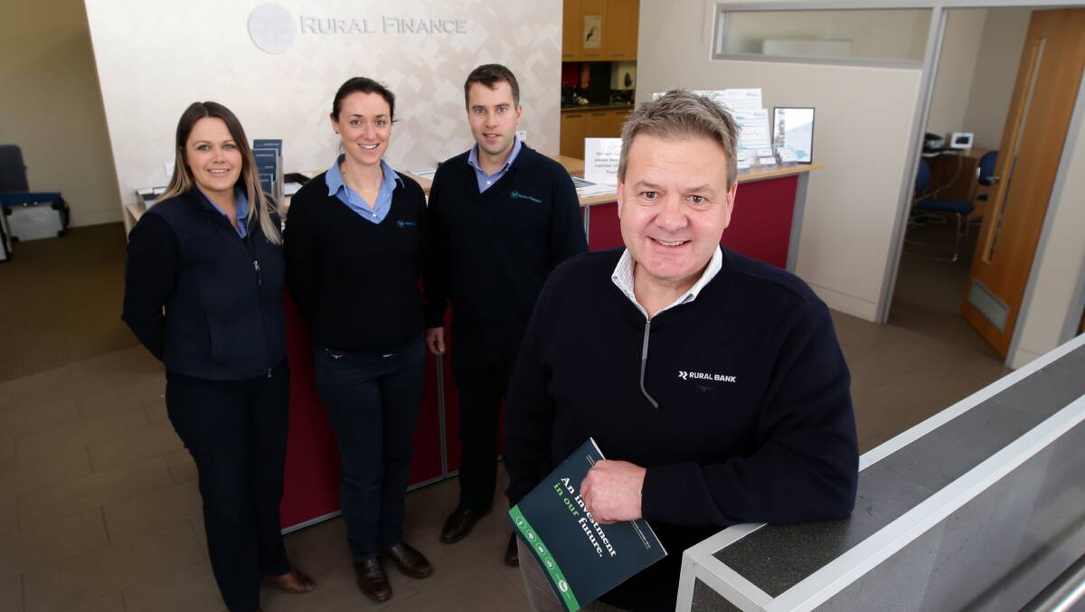 Rural Bank managing director and chief executive Paul Hutchinson (right) updates Warrnambool Rural Finance office staff Michelle Butters (left), Katie O’Toole and Andrew Nevill. 