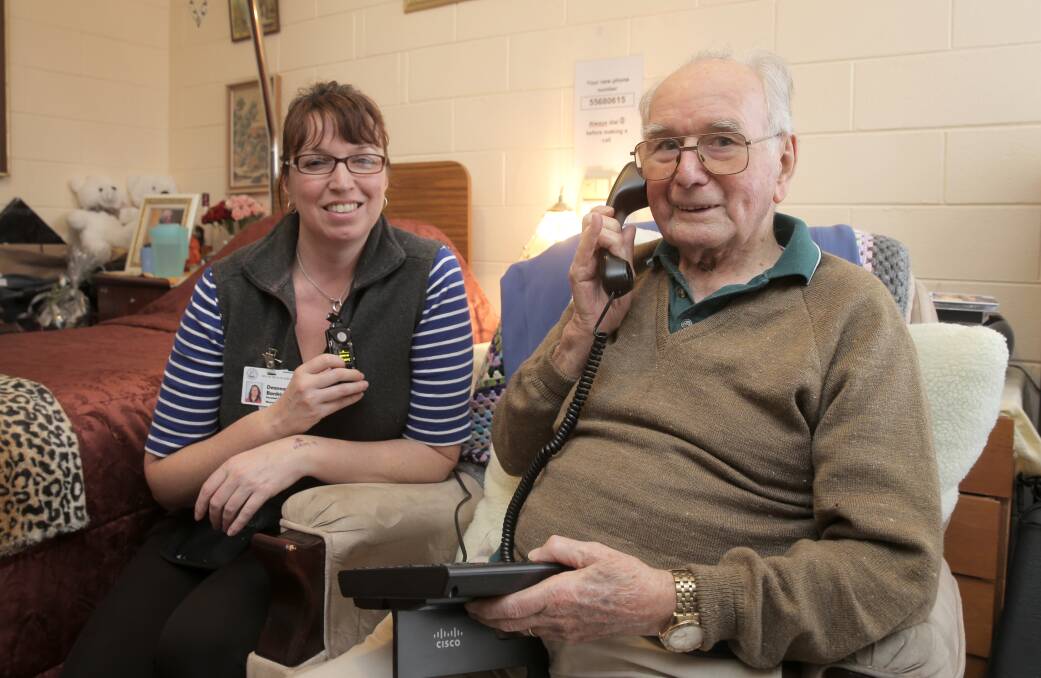 Moyneyana House personal care worker Deanna Bankier holds the new communication system that staff can use to help stay in touch with residents such as Tom Ross. 140708RG05 Picture: ROB GUNSTONE