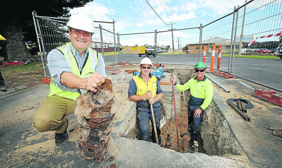 Wannon Water project  manager Simon Perrin (left) with an old cast iron pipe fitting, part of the ageing supply network being replaced by Jason Warburton and Tony Rix from Cri-Tech Plumbing. 150317DW40 Picture: DAMIAN WHITE