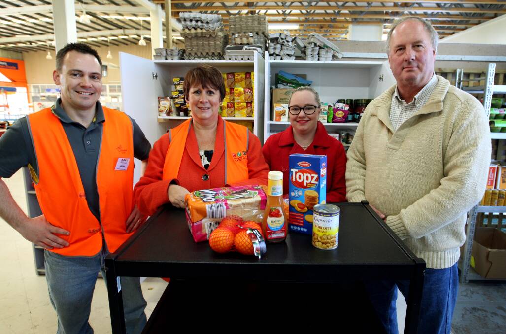 Volunteers Leigh Grinton (left) and Rhonda Henry from the Commonwealth Bank and Edwina Goodall from Warrnambool Timber Industries with Warrnambool and District Foodshare board member Don Swanson.140820lp09 Picture: LEANNE PICKETT