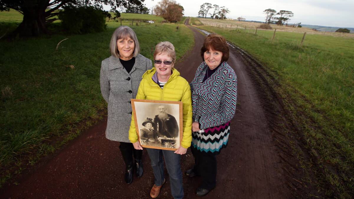 Sisters Jillian Lynch (left), Claire Reynolds (holding a picture of Margaret and John Savage) and Pam Savage on the soon-to-be renamed Savages Lane near Cobden. 140721DW42 Picture: DAMIAN WHITE