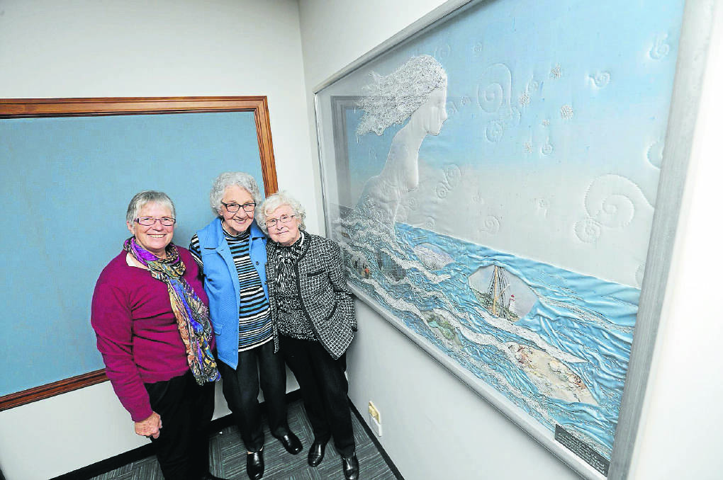 The South Western branch of the Embroiderers Guild will celebrate its 40th anniversary on November 8 by unveiling a commemorative artwork. Branch president Robyn Archer (left), with Phyllis Brown and Gloria Cathcart display a previous artwork in which they participated. 141003VH21 Picture: Vicky Hughson