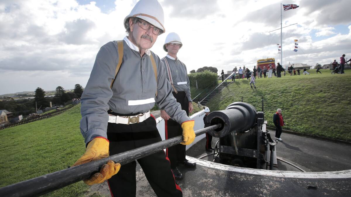 Ken Ryan (left) and Steve Ivey clean the cannon at Flagstaff Hill which was fired three times yesterday for a Day on the Hill.