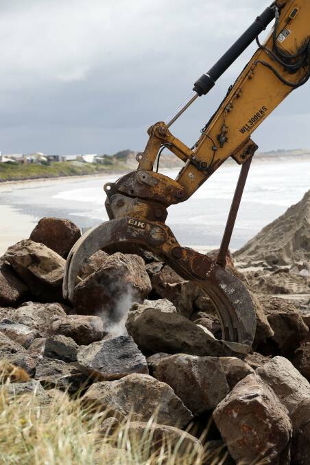 Work in progress: boulders to prevent sand erosion are formed into a rock wall on Port Fairy's East Beach. 