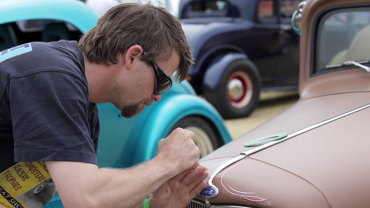 Craig Issell, of Lethbridge, shows his control as he puts some pinstriping on the front of his father's 1932 Ford Coupe. 