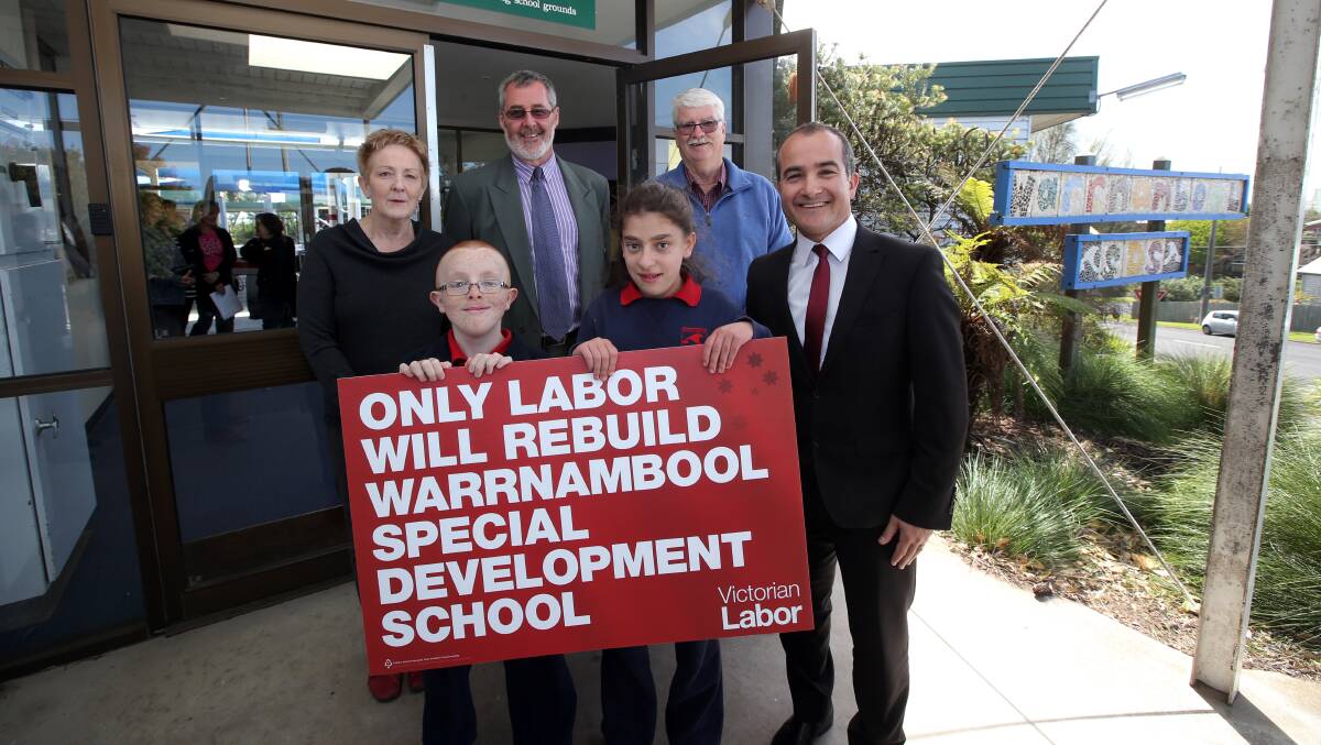 Warrnambool Special Development School acting principal Sue Fraser (from back left), ALP candidate Roy Reekie, school council president Ken Gale and Shadow Minister for Education James Merlino (far right) celebrate with students Jordan Sherrard and Madilyn Hunt after ALP announced its support to relocate the school. Picture: DAMIAN WHITE 