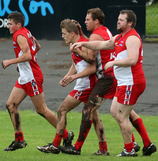 Teammates congratulate Kyden Jarvis after one of the 16-year-old's five goals.