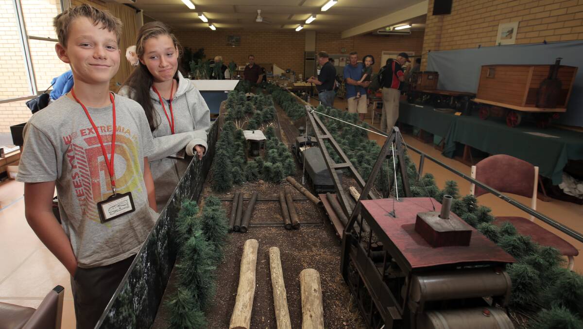 Emiel, 13, and Abigail Morevell, 15, of Kerang, help out with one of the train displays. 