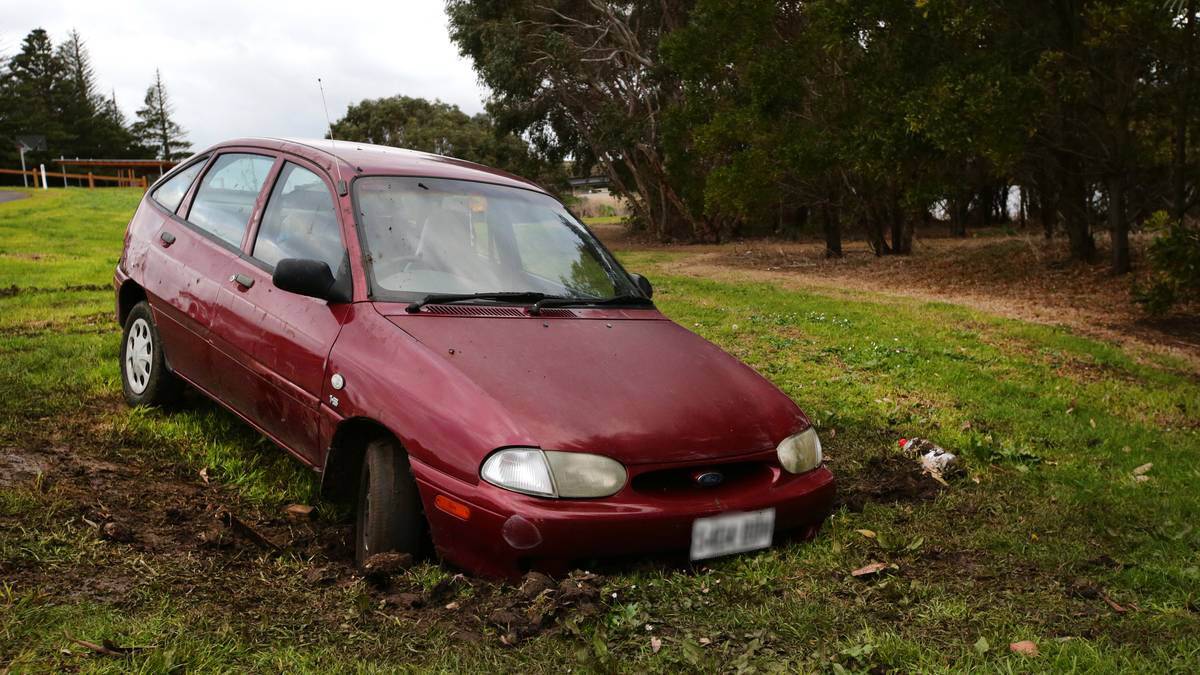 This car became bogged at Payne Reserve in Dennington after its driver told police he had been fishing in the Merri River. Earlier last month another car also tore up turf at the reserve. Picture: AARON SAWALL