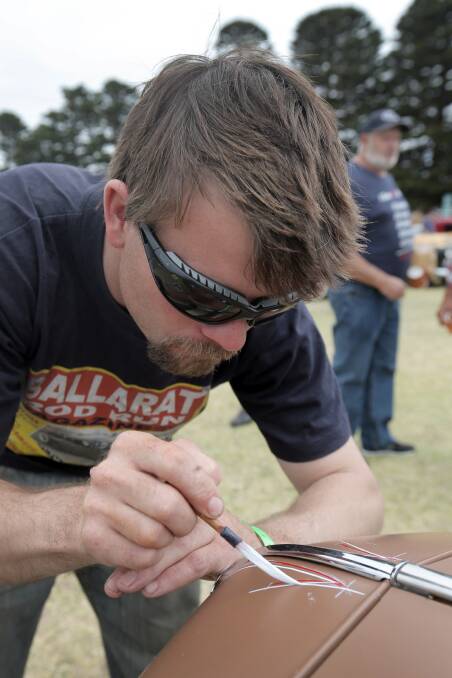 Craig Issell, of Lethbridge, shows his control as he puts some pinstriping on the front of his father's 1932 Ford Coupe. 