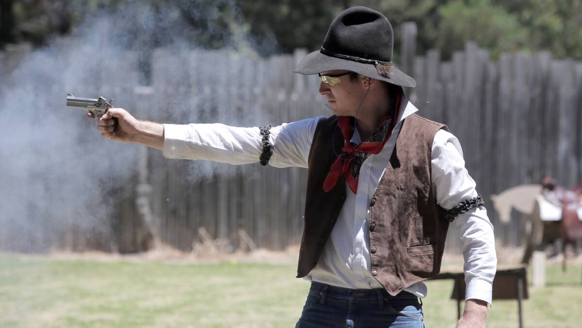 Kyle "Mad Dog" Pearse, of Bendigo, takes aim with a replica Derringer pistol. 