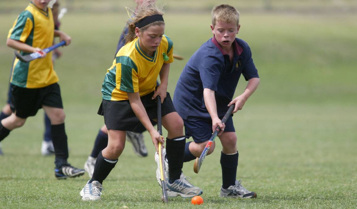 Heywood's Lauren Handeck - 11 and Hamilton-Alexandra college's Bowes Kelly fight it out for control in the interschool hockey final at Warrnambool.