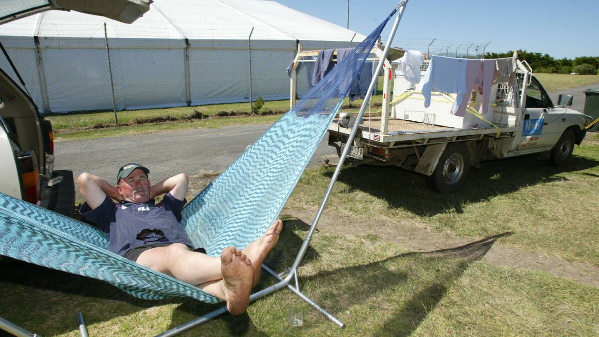 Barry Ryan from Cobden, pictured relaxing in his hammock, beside his family's camp site at Port Fairy's Southcombe Park with the Folkie grounds behind.