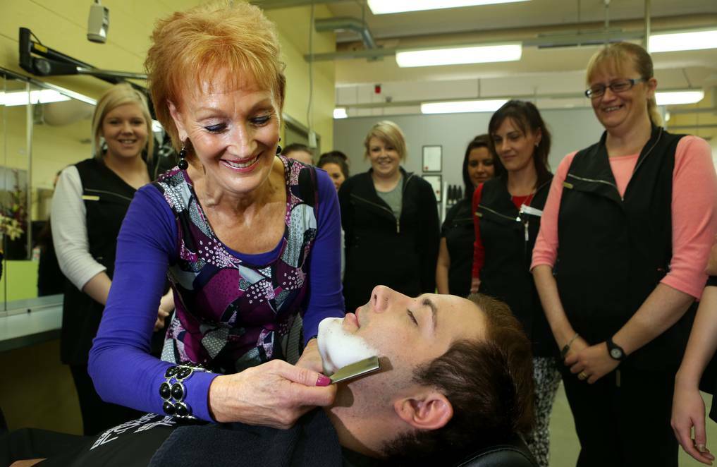 Hairdressing co-ordinator at South West TAFE Jenny Best-McCosh demonstrates the fine art of shaving with a cut-throat razor.