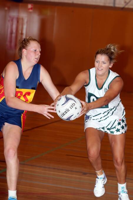 Hampden White keeper Kasey Owen and Warrnambool shooter Stephanie Jamieson fight for the ball. 