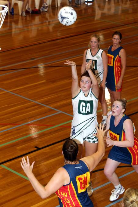 Sharni Moloney shoots, watched by teammate Lisa Couch and defenders WD Liz Fowler, GD Kate Ryan and GK Lisa Anders. 