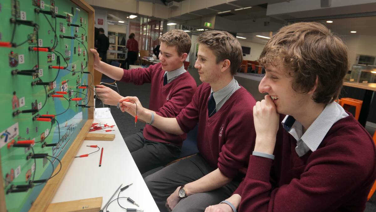  Kings College year 10 students Ben Cressall, 16, William McIvor, 16, and Karl Johns, 16, plan out their electricity grid.