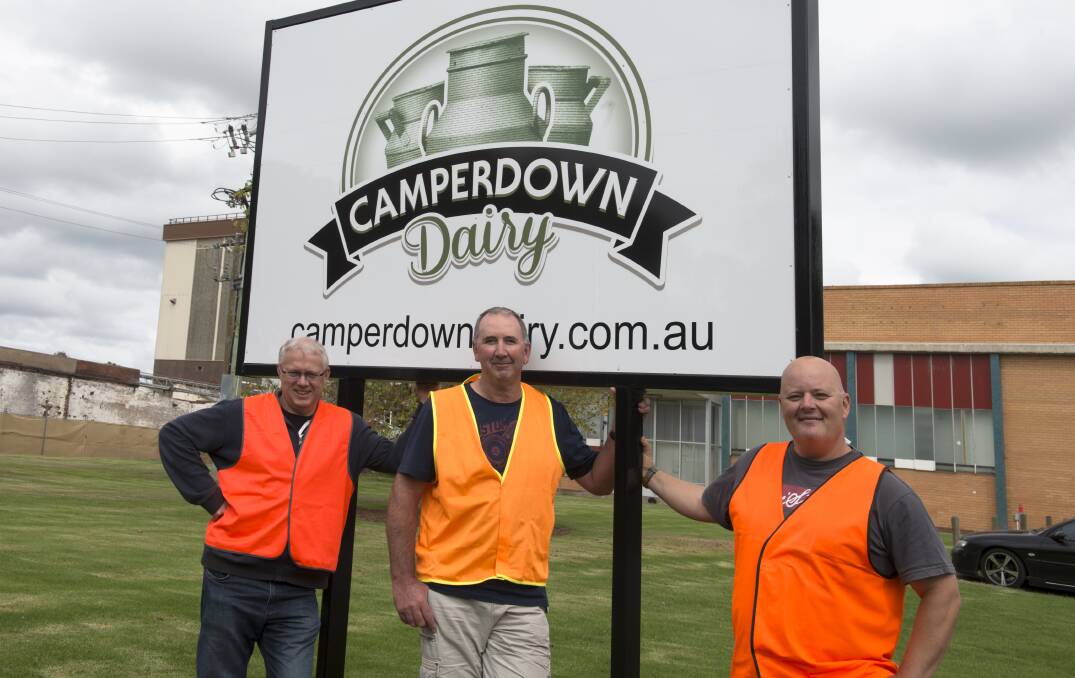 Camperdown Dairy quality and risk co-ordinator Gary Black (left), production co-ordinator Andrew Giles (centre) and site co-ordinator Paul Brown with the new signage at the Camperdown factory. Picture: STEVE HYNES
