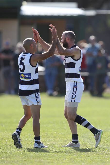 Matt Lenehan, pictured celebrating with coach Jason Saunders, booted nine goals on Saturday.