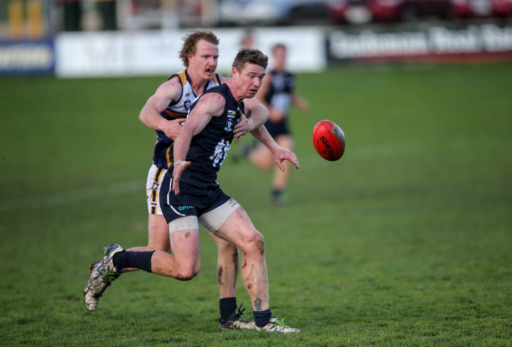 LIKE A GLOVE: North Warrnambool Eagles' Luke Wines battles Warrnambool's Rob Bright for the ball. Picture: Christine Ansorge