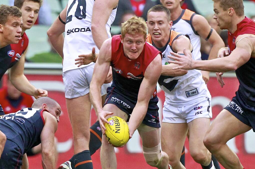 TOUGH MID: Terang Mortlake recruit Jordie McKenzie, pictured bursting out of a pack when playing for Melbourne in 2012, has returned to the club he played his junior footy at. Picture: The Age