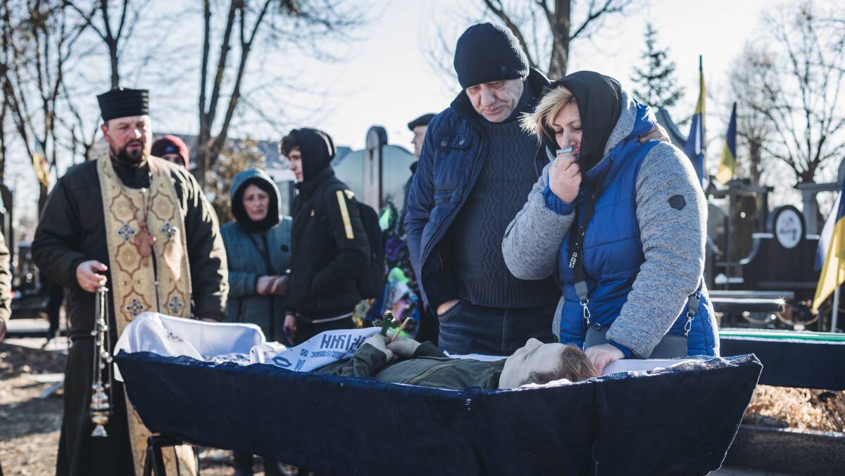 The mother of a deceased Ukrainian soldier cries at a cemetery in Kyiv, Ukraine, on Thursday. Picture: Getty Images