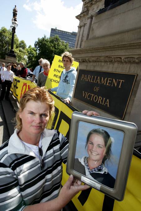 People power: Garvoc's Dominique Fowler holding picture of her daughter Alycia, who was killed in car accident, on the steps of parliament house in Melbourne. A busload of media and community members took their campaign for a rescue helicopter right to the top in 2008.