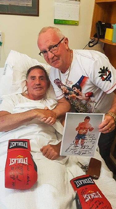 PUT it there: Jim Pevitt with some of Barry Michael's boxing memorabilia. Picture: Jo Coomber