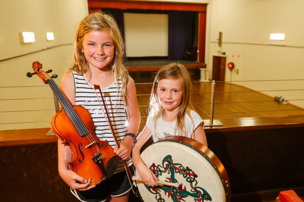 Music: Neve MacDonald, 10, and Ava Timewell, 6, play instruments at the back of the Koroit Theatre. A live cross video to Dublin will take place at the venue during this year's Koroit Irish Festival. Picture: Morgan Hancock.