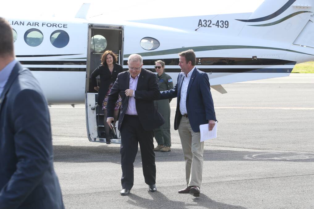 FLY in, fly out: Federal Member for Wannon Dan Tehan (right) meets Prime Minister Scott Morrison at Warrnambool airport yesterday with Member for Corangamite Sarah Henderson (rear). Picture: Michael Chambers